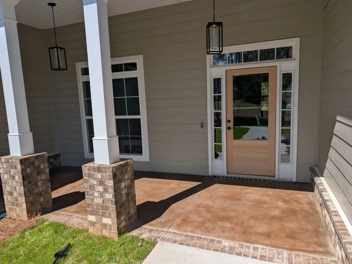 Stained concrete front porch with brick columns