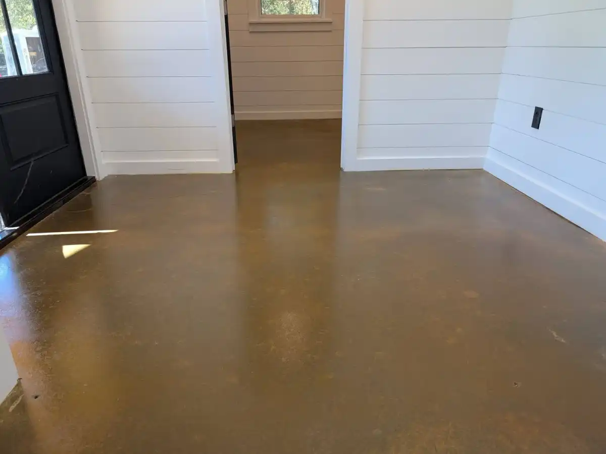 High-gloss stained concrete in a white shiplap entry