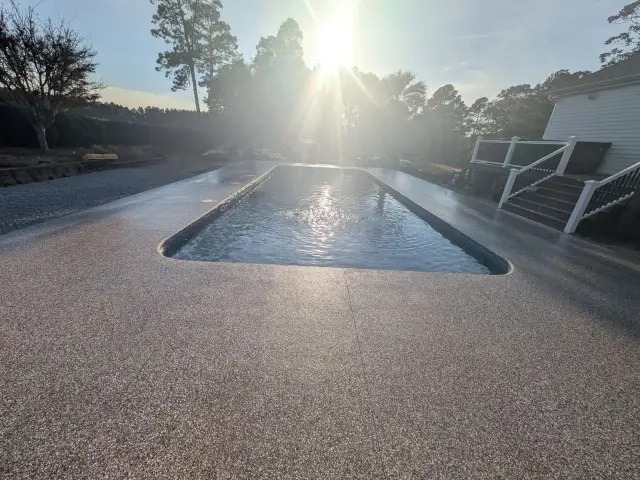 Coated pool deck in late-afternoon sun