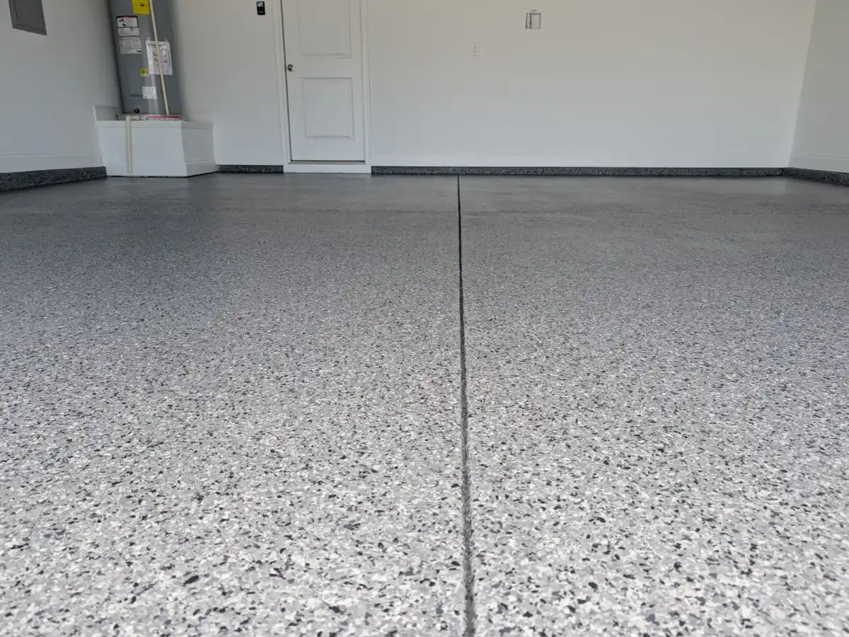 Close view of a finished gray flake floor along a control joint