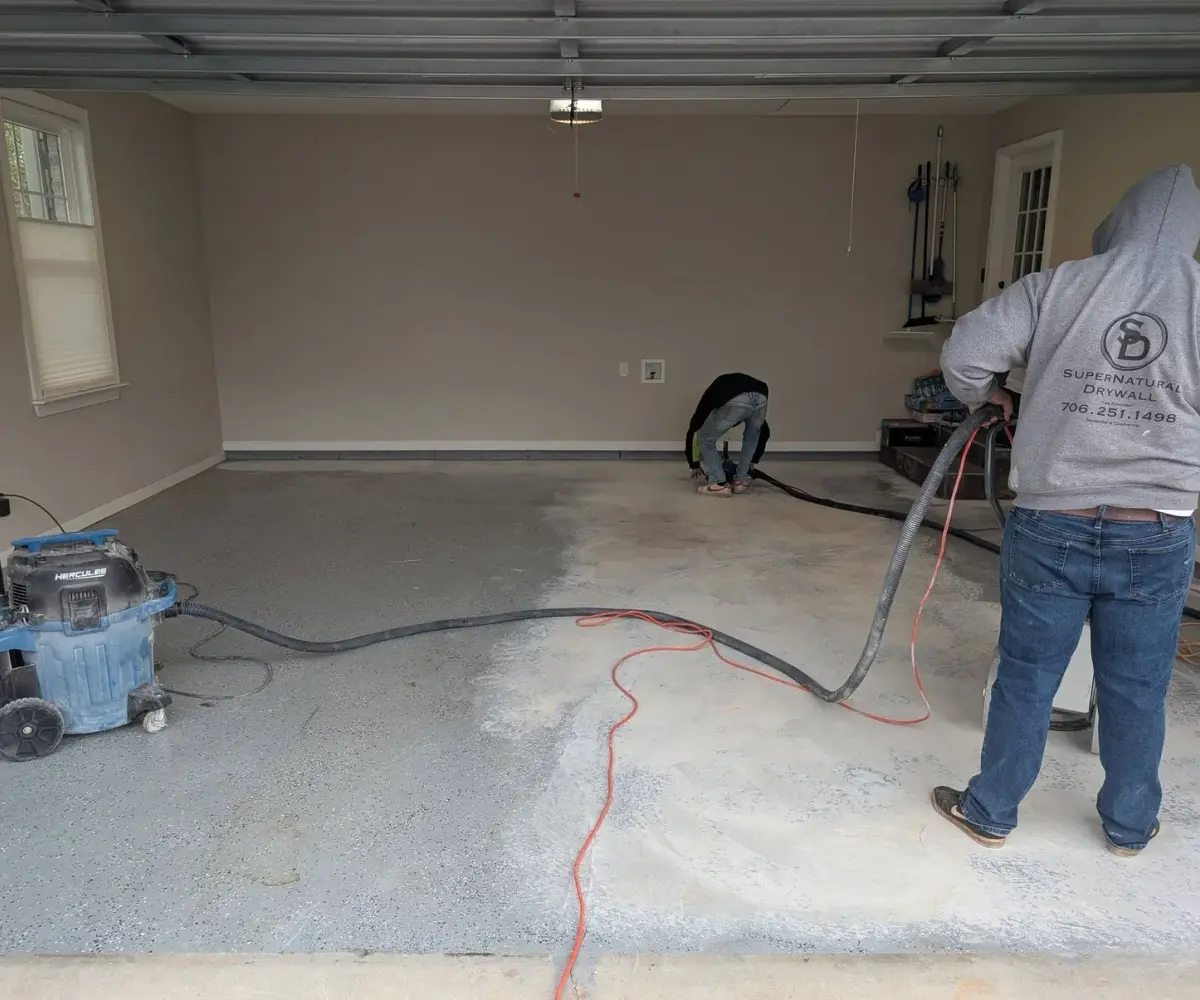 Crew diamond-grinding a garage slab before coating