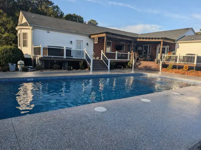 Coated pool deck in a large backyard