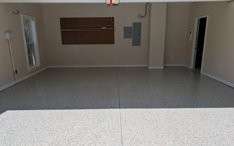 Freshly coated gray flake garage floor in an empty garage