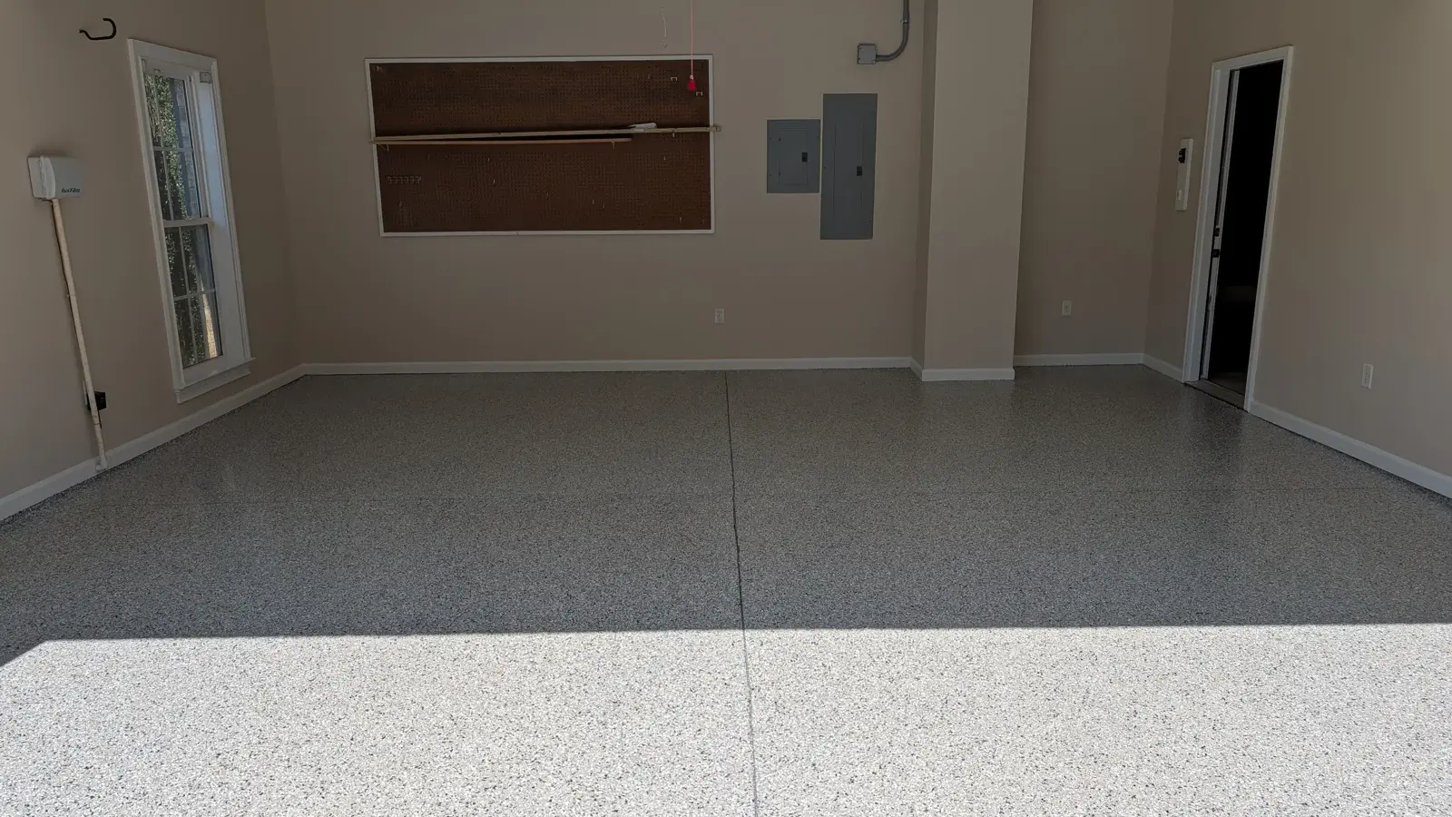 Freshly coated gray flake garage floor in an empty garage