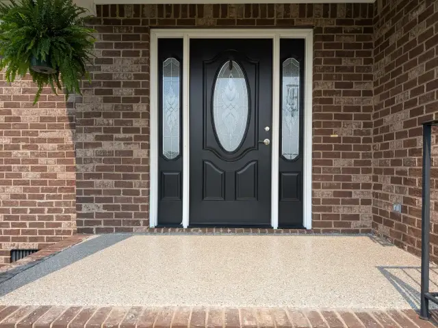 Tan flake front porch at a brick entry