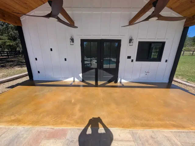 Stained concrete porch at a white barn-style building
