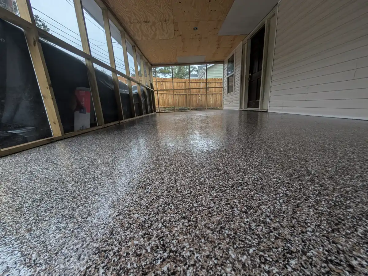 Dark flake floor on a screened back porch with a pine ceiling