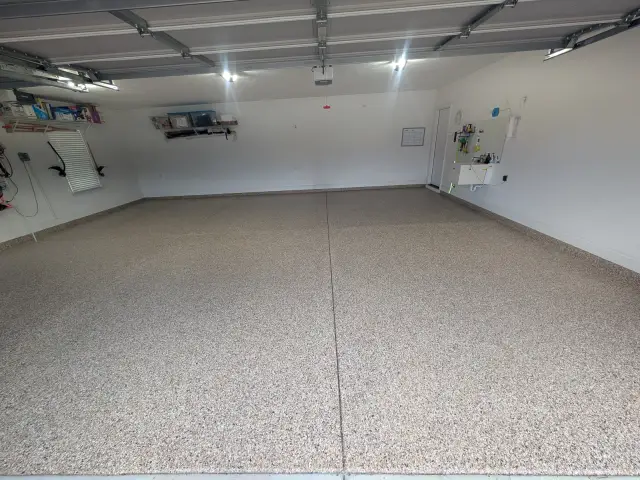 Bright garage with a flake floor under overhead lights