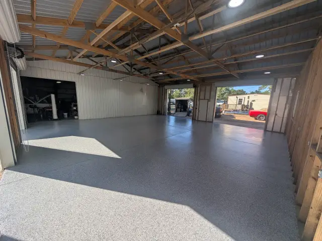 Open shop with wood trusses and a flake floor