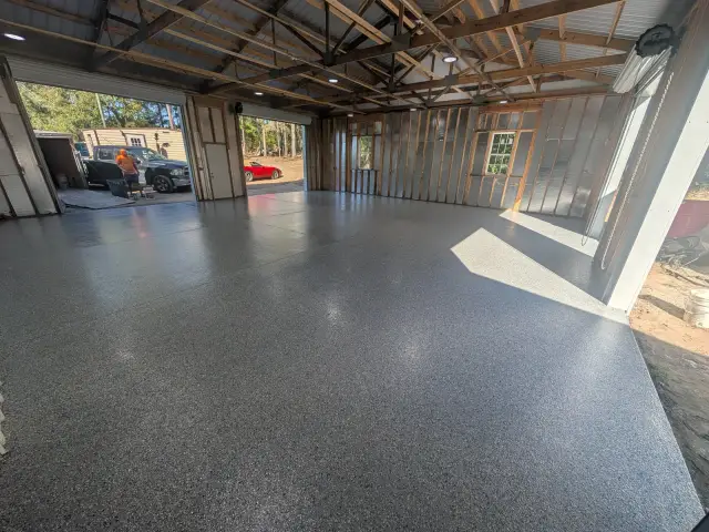 Large trussed shop building with a gray flake floor