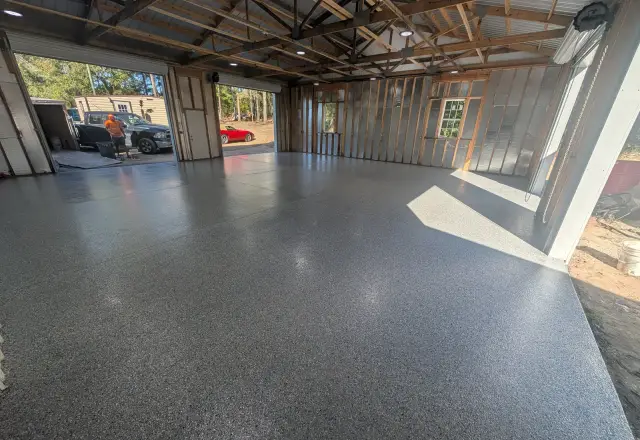 Large trussed shop building with a gray flake floor