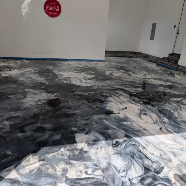 Black and silver metallic epoxy floor with marble-like swirls