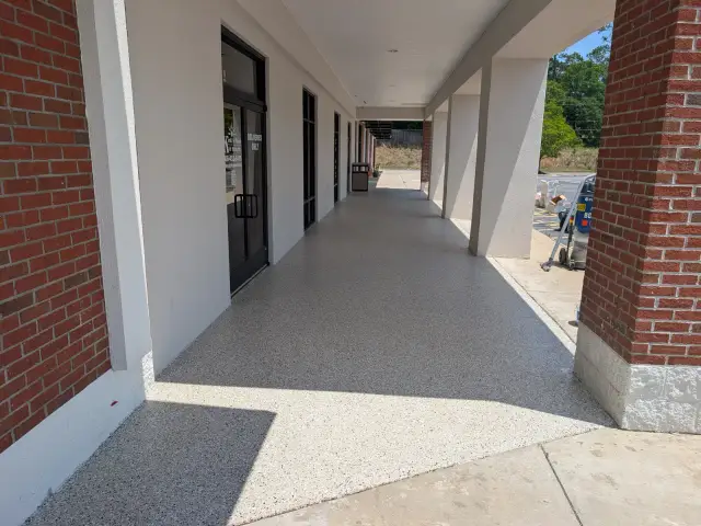 Light flake walkway along a covered brick porch
