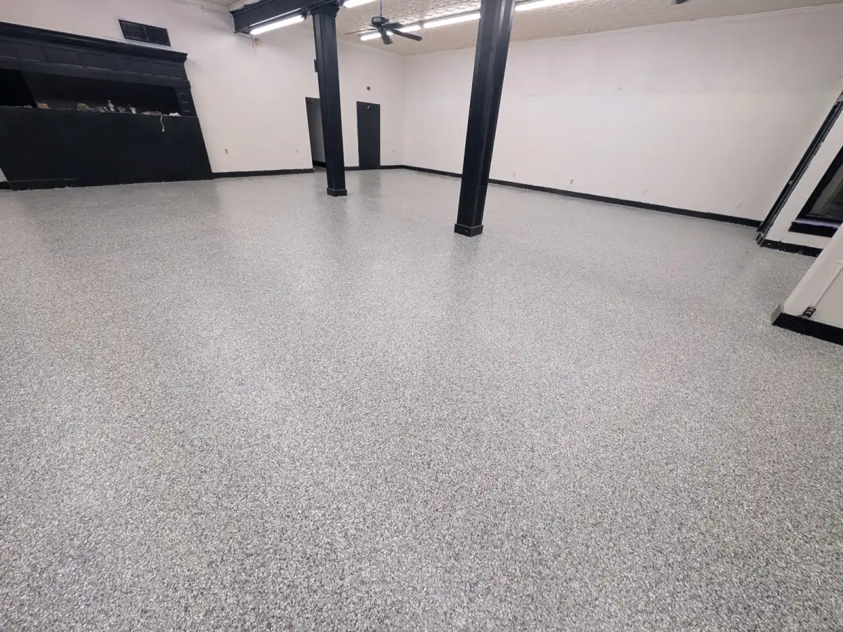 Gray flake commercial floor in a large interior with steel columns