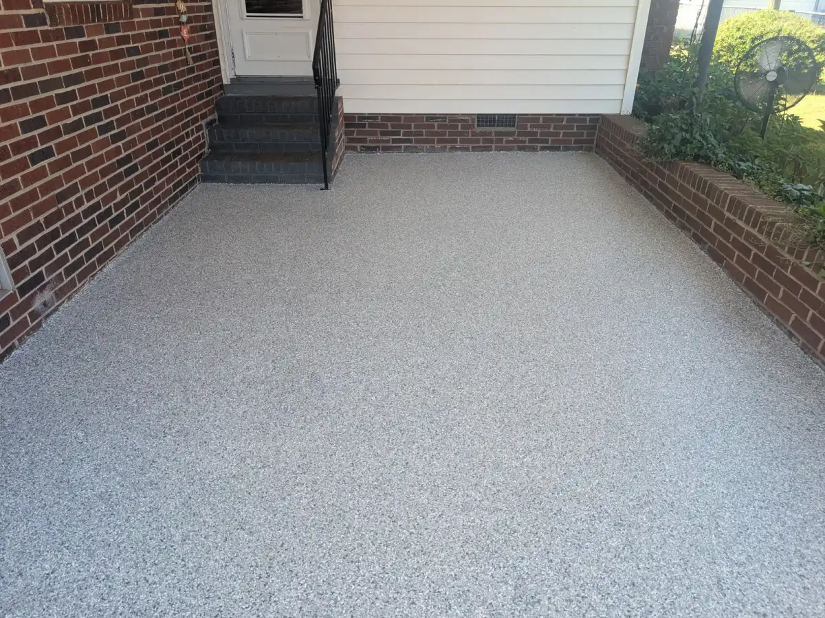 Light flake front porch beside brick walls and a screened door