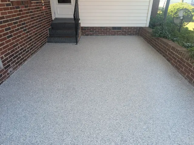 Light flake front porch beside brick walls